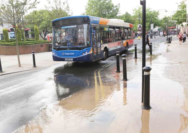 A Stagecoach bus makes its way through leaking water on Chapel Road