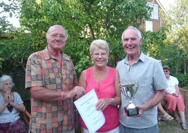 Dudley Rushmere, Chairman of Beeding in Bloom is presenting the Jim Heritage Cup to Joan and Roger Hornsby whose garden was judged to be the best entry overall.