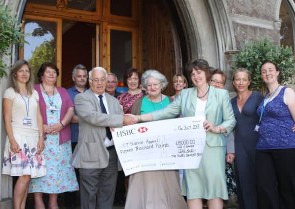 Mrs Carole Baker hands the £15,000 cheque to Ron Noakes, chairman of the Friends of Worthing Hospitals
