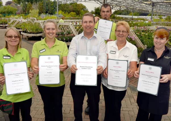 Haskins Group retail operations manager Dean Ridley (front, centre) and Roundstone Garden Centre staff with the six Garden Centres Associaton award certificates