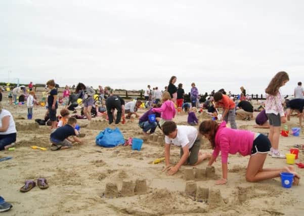 Sandcastle builders hard at work on Littlehampton beach.