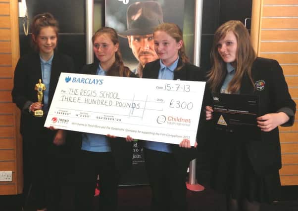 Students from the Regis School with their prize