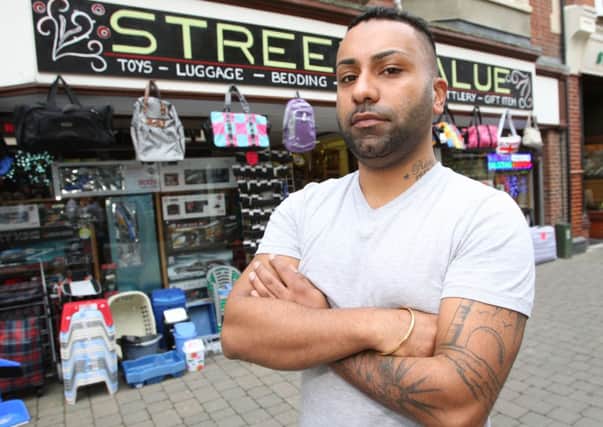 Ricky Juneja, pictured in October 2011, frustrated by shoplifters targeting his shop in West Street. Horsham -photo by steve cobb