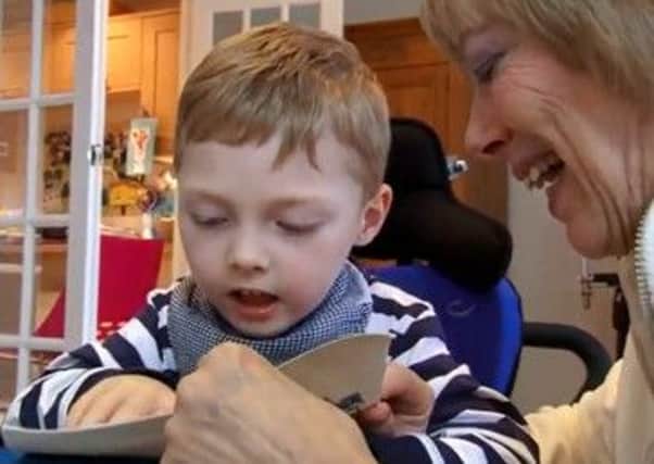 Angmering boy Samuel Pallant, four, enjoys some fun and games with his carer Sue Smith