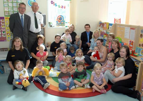 Staff and children celebrating their new nursery opening in 2010               L37048H10
