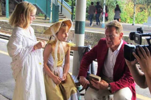 Broadcaster Michael Portillo interviewing children during the Victorian day at Arundel railway station