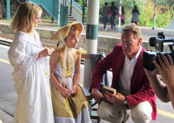 Broadcaster Michael Portillo interviewing children during the Victorian day at Arundel railway station