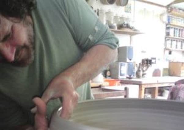 The artist Josse Davis working in his potters studio.