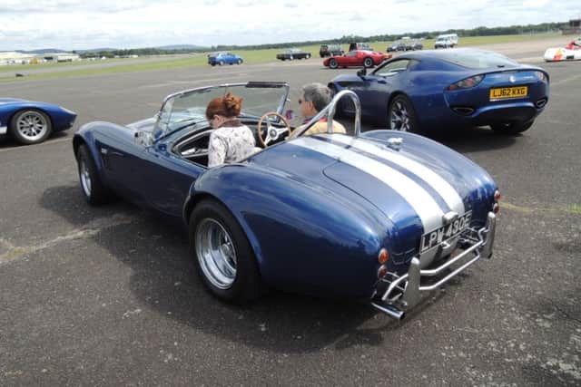 Another volunteer passenger tries out the AC Cobra.
