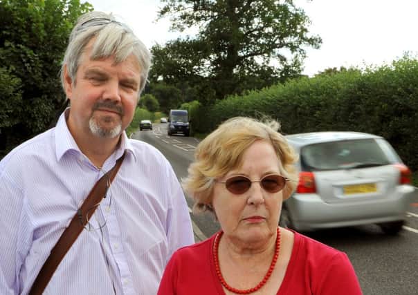 JPCT 120813 Gevin White and Caroline Charman, both Lower Beeding parish councillors angry about speeding bikers. Photo by Derek Martin