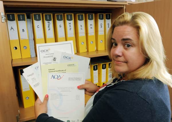 Exam officer Joanne Dean with folders containing hundreds of unclaimed exam marks  L34523H13