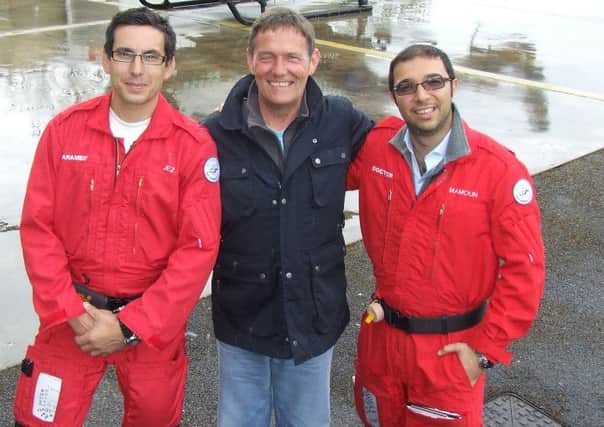Paul Aylward with the doctor and paramedic who saved his life