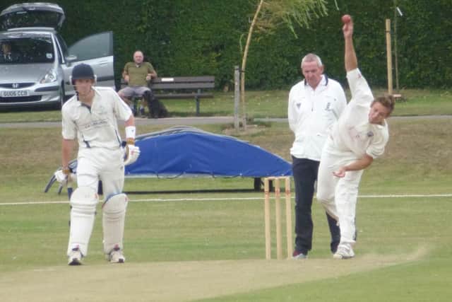 Elliot Guest bowls for Bexhill as Crowhurst Park batsman Bradley Payne looks on. Picture by Simon Newstead