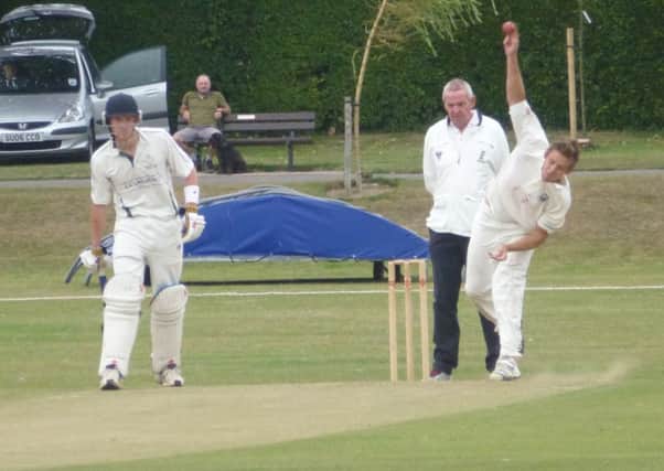Elliot Guest bowls for Bexhill as Crowhurst Park batsman Bradley Payne looks on. Picture by Simon Newstead