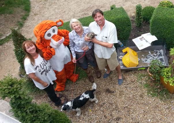 Mary Reed with Tigger, Bella the tortoise and her owners Mr and Mrs Gammond at Pooh House and Gardens in Fittleworth