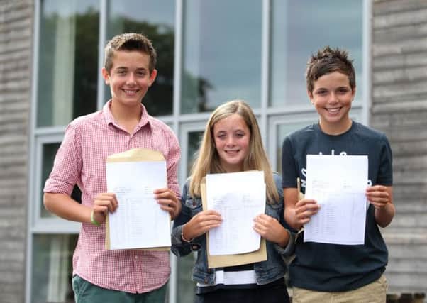 Triplets Conall Bartlett, Niamh Bartlett and Deaglan Bartlett pose for a photo after receiving their GCSE results at St Paul's Catholic College. Photo by Jordan Mansfield)