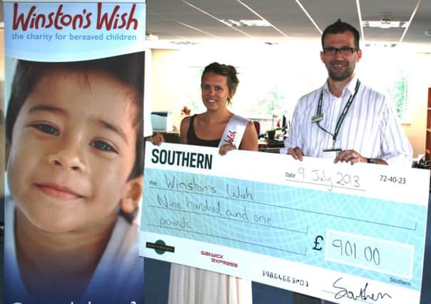 Louise Brown, of Winston's Wish, receives the cheque for £901 from Ben Read, Southern's Littlehampton traincare depot manager