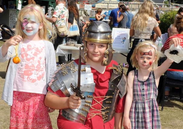 Bryony Petter, seven, with Roman Den Woodson, 13, and Anya Petter, five, at Arundel Museum's Hands-on History event   L35004H13
