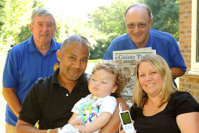 JPCT 270813 Chanctonbury Lions Club helps Maxwell Smith 18 months. Lions Alan Jenkins left and Les Wilson with Maxwell and parents Peter and Emma. Photo by Derek Martin