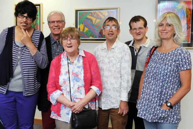 JPCT 230813 S13350012x Horsham. County Hall North. Starburst Arts. Artwork on display in Council building. Joanna, Peter Catchpole, cabinet member for adult services and health WSCC, Lynda, Mark, Daniel and Sally Christopher, community connector for Starburst Arts -photo by Steve Cobb