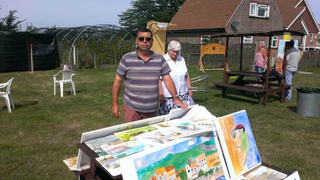 Alastair Riddell selling some of his artwork at The Apuldram Centre summer fete