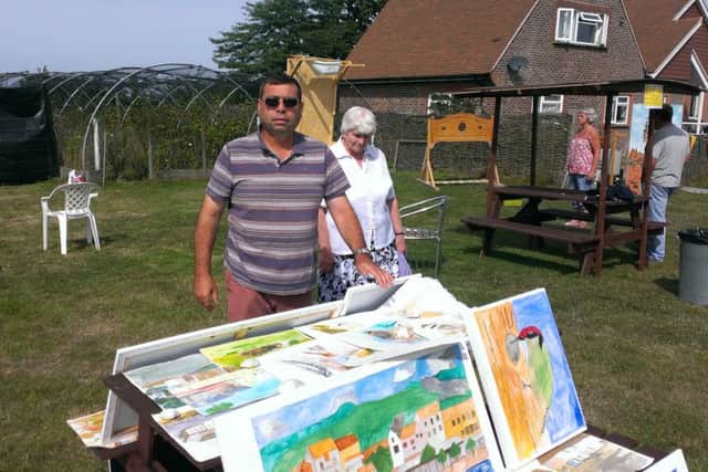 Alastair Riddell selling some of his artwork at The Apuldram Centre summer fete