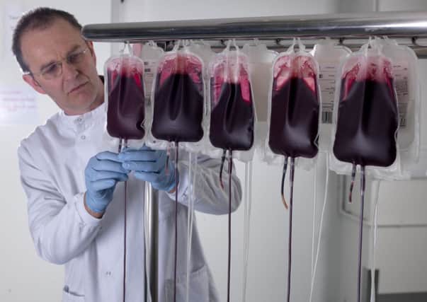 Scientist inspecting blood bags. Photo courtesy of NHSBT