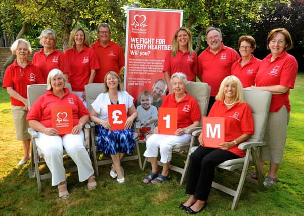 local British Heart Foundation volunteers celebrate the regional branch achievement of raising £ 1,000,000