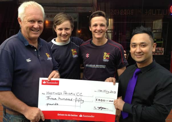 Hastings Priory chairman Ian Gillespie, and first team players Jake Woolley and Elliot Hooper receive a cheque from Mr Syed, of Cinnamon Spice, one of the club's sponsors