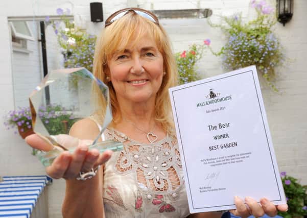 JPCT 040913 Amanda McLaughlin, landlady of The Bear, Market Square, Horsham,  has won awards for her Garden - one from Horsham in Bloom and another from Hall and Woodhouse. Photo by Derek Martin