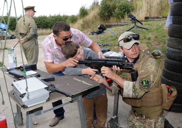 Aouis O'Neil, six, with Arif Jarvis and Chris Davies from Ford Airsoft   L37259H13
