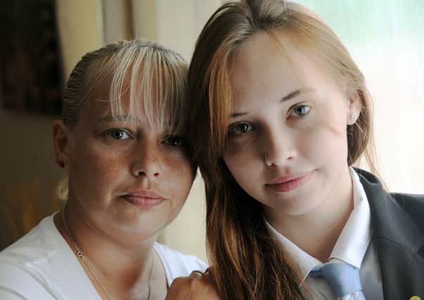 Zandra Phillips with daughter Amber, 15, who was sent home because she had a nose piercing          L38587H13