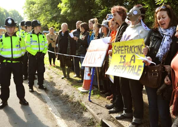 Anti fracking protesters chant and sing from the confines of a police approved area. Pic Steve Robards