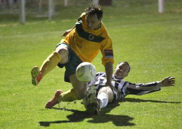 Jamie Cade is challenged by Tom Lawley in the wet - pictures by John Lines