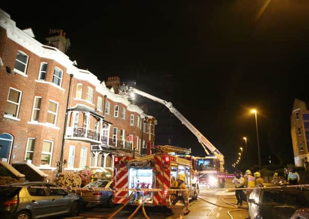 Emergency services use a ladder to rescue a woman trapped inside the burning flat complex    PHOTO: Eddie Mitchell