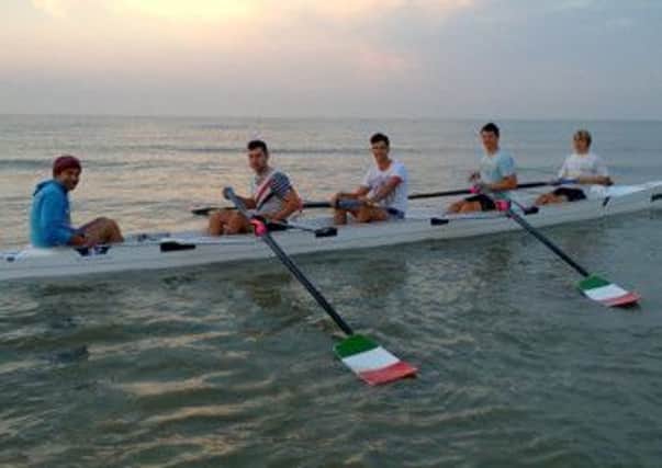 Bexhill Rowing Clubs mens junior four crew of Lee Dunstall (cox), Jack Page, Josh Green, Rob Johnson and Alex Pepper about to start training at 6am on Bexhill beach