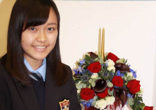 Mana Otashiro and her prize-winning floral arrangement