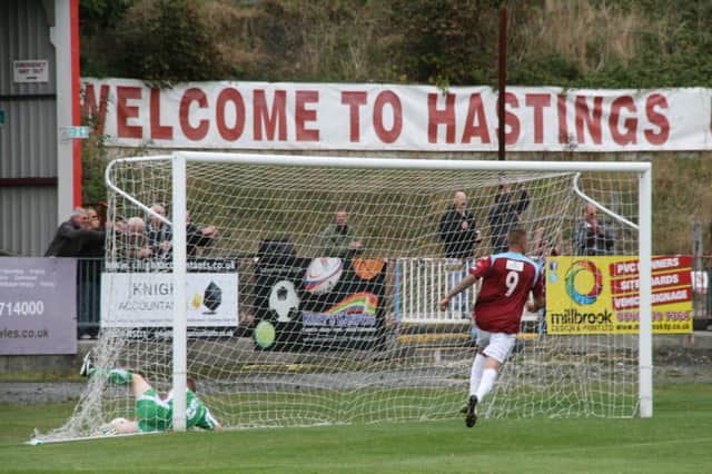 A Guernsey defender can't prevent Bailo Camara scoring Hastings United's first goal at The Pilot Field on Saturday. Picture by Terry S. Blackman