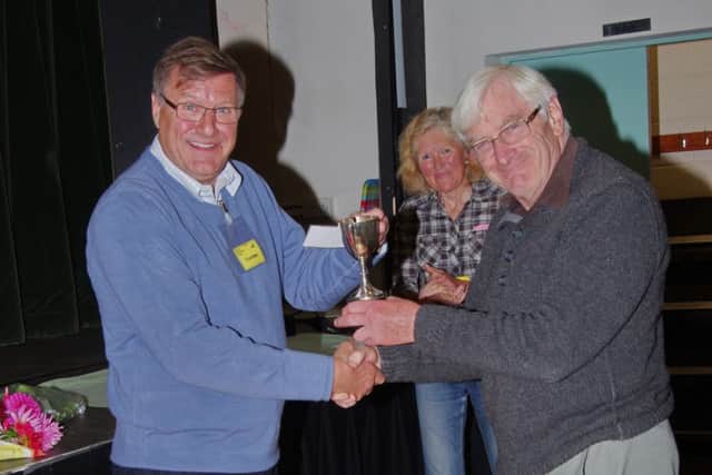 Chairman John Dyball presents cup to Alan Moody, Zoe Horton show secretary looks on