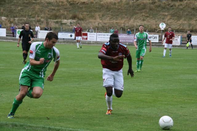 Bailo Camara challenges for the ball during Hastings United's game at home to Guernsey last weekend. Picture by Terry S. Blackman