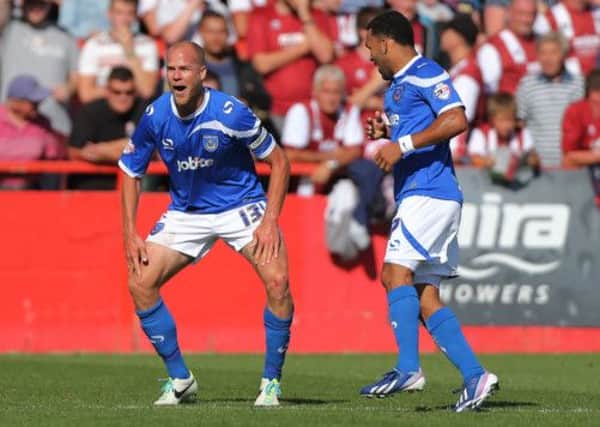 Portsmouth's Johannes Ertl (left) celebrates scoring the second goal against Cheltenham Town during the Sky Bet Football League Two match at the Abbey Business Stadium, Cheltenham.