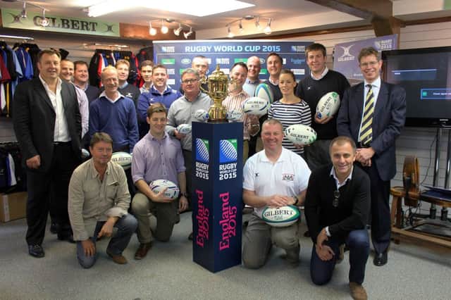 The Gilbert sales and management team with the Webb Ellis Trophy