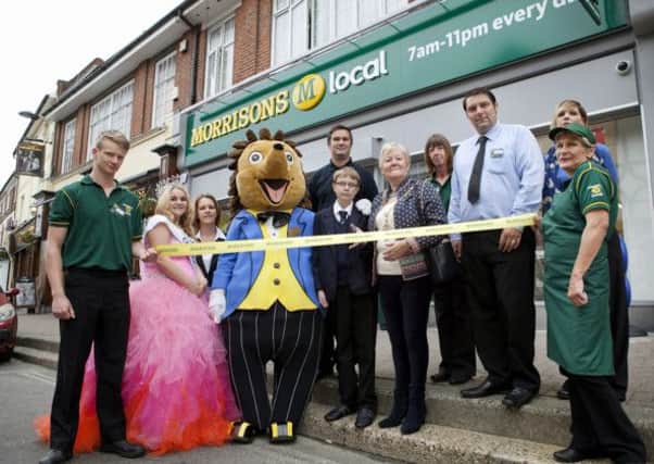 Town mayor Joyce Bowyer, centre, cuts the ribbon of the new Morrisons M local site     PHOTO: David McHugh