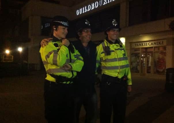 Officers pose for a photograph with a reveller