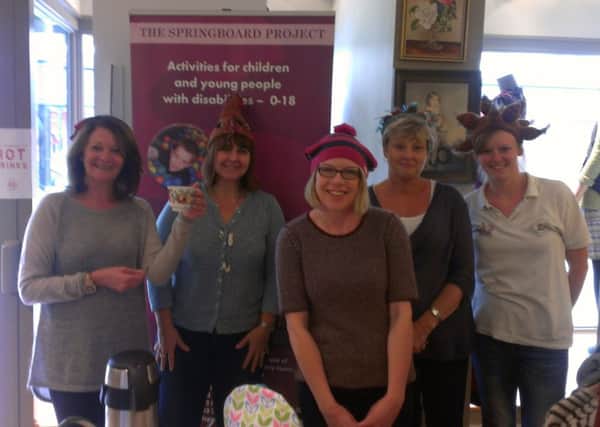 Staff at White Stuff on National Wear a Tea Cosy on Your Head Day