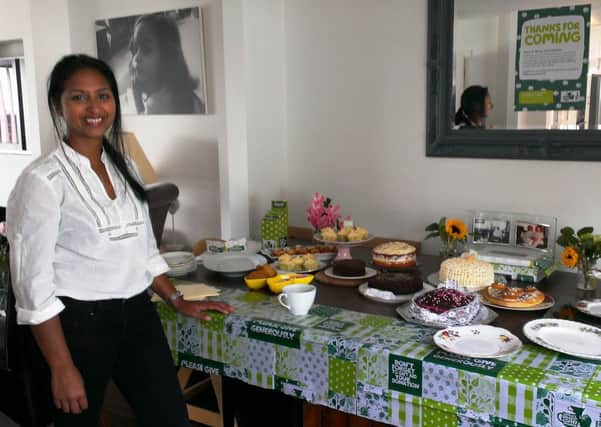 Michelle de la motte-Rice with the table of cakes at her coffee morning in Mill Hill, Shoreham