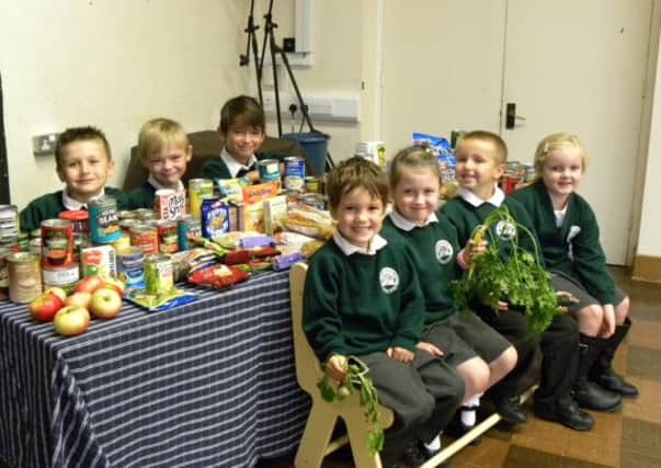 Children with their harvest of goodies at White Meadows Primary School, WIck