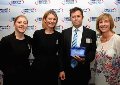 Daniel Oliver collecting the award on behalf of Sussex Cricket League colleague Peter Butter, from Heather Knight,
Charlotte Edwards and Clare Connor
