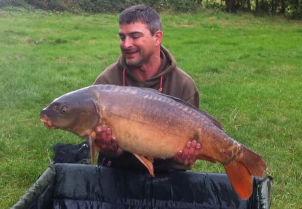 David Harland with the largest fish ever recorded at Wylands International Angling Centre
