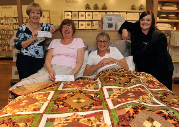 Quilt makers and Friends of the St Richard's Hospital Jane Ramage, (left) Sue Barge, and  Jac Hepworth with John Lewis shop manager Claire Dunkason


Picture by Louise Adams C131335-1 Chi Eye Appeal